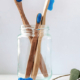 a group of toothbrushes in a glass jar